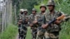 Indian Border Security Force (BSF) soldiers patrol near the India Pakistan border fencing at Garkhal in Akhnoor, about 35 kilometers west of Jammu on August 13.