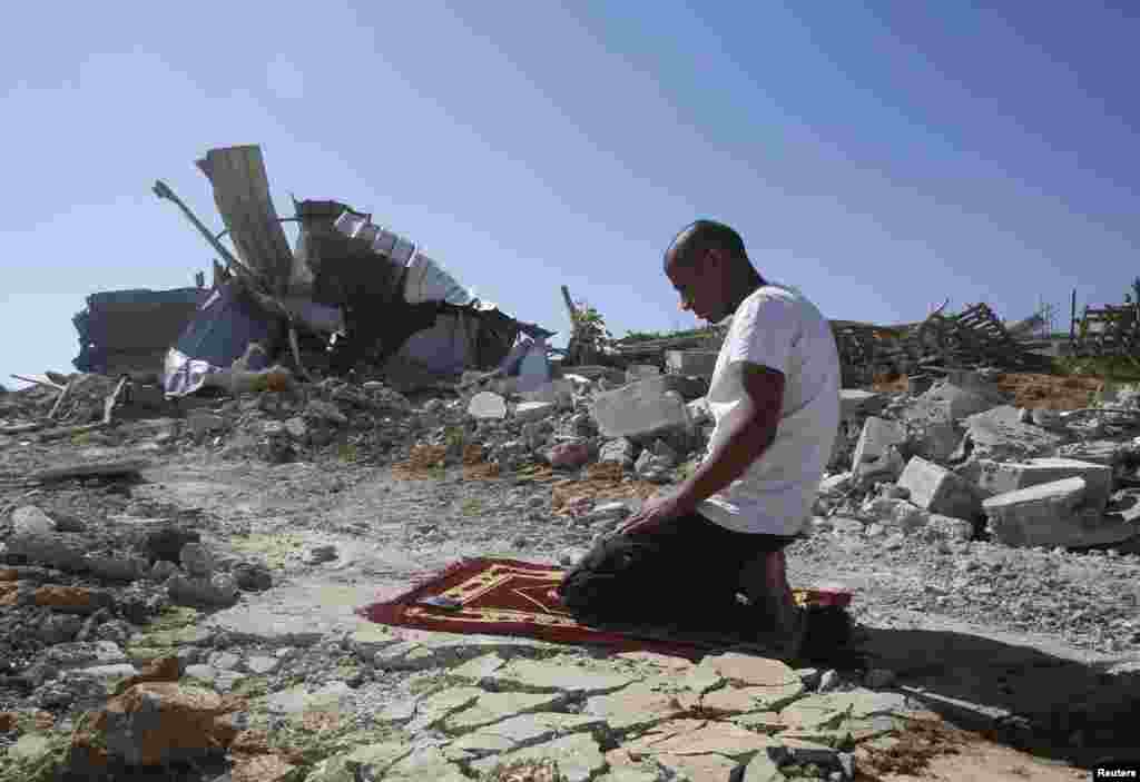 A Palestinian Bedouin man prays near his dwelling, which was demolished by Israeli bulldozers near Hebron on October 27. (Reuters/Mussa Qaqasma)