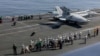 A handout photograph released by the US Navy on February 8 shows observers including US envoys Steve Witkoff and Jared Kushner as they watch operations on the flight deck of the USS Abraham Lincoln aircraft carrier. 