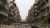 A bus blocks a road amid damage on the Salah Al-Din neighbourhood frontline in Aleppo December 6, 2014.