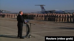 Russian President Vladimir Putin orders a partial troop withdrawal from Syria during a surprise visit to Russia's Hmeimim air base in Syria's Latakia Province on December 11.