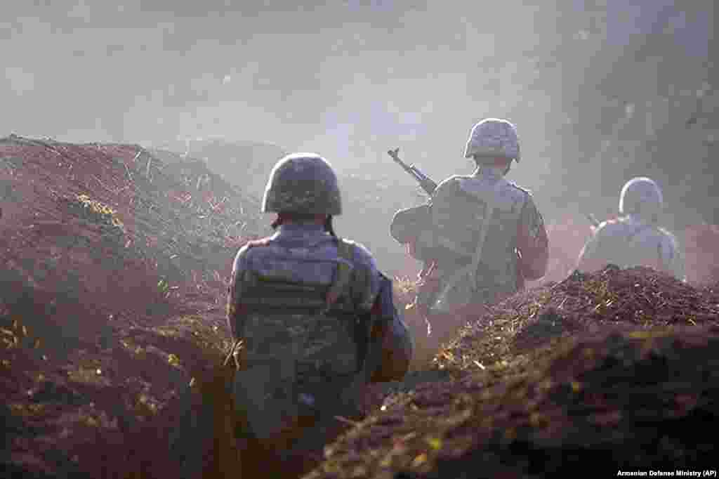 Armenian soldiers take their position on the front line in the Tavush region amid clashes at the border with Azerbaijan on July 14. (AP)