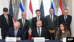 US Secretary of State Marco Rubio (center, back) looks on as Israeli Ambassador to the US Yechiel Leiter, State Department Chief of Staff Daniel Holler, and Lebanese Ambassador to the US Nada Hamadeh sign a framework agreement in Washington, D.C. on June 26.