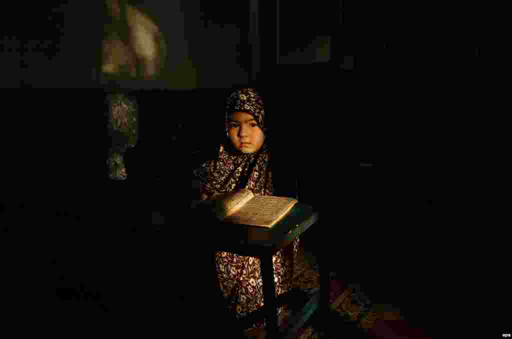 An Afghan girl reads the Koran at a mosque during the holy month of Ramadan in Kabul on May 30. (epa/Hedayatullah Amid)