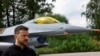 Ukrainian President Volodymyr Zelenskiy speaks in a front of an F-16 fighter jet after marking the Day of the Ukrainian Air Forces at an undisclosed location on August 4.