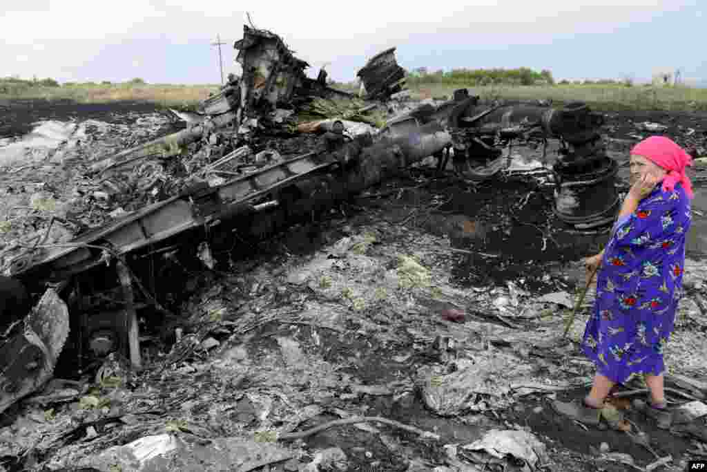 A local resident stands amid the wreckage at one of the crash sites near Hrabove on July 19.