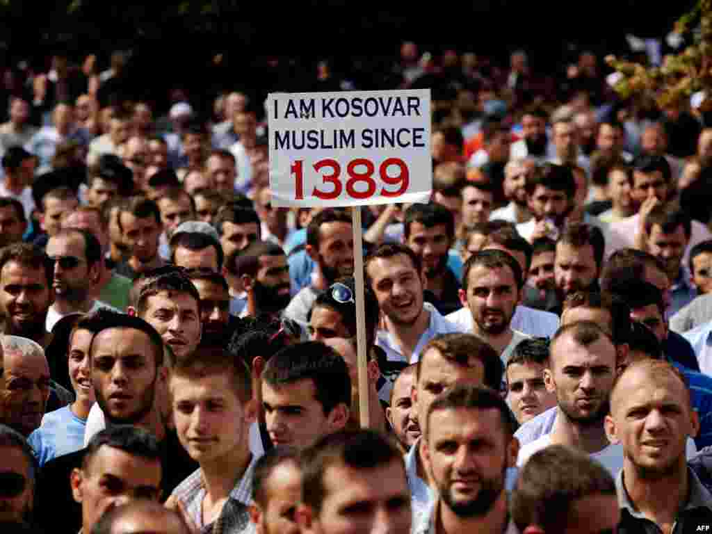 Kosovar Muslims protest after Friday Prayers against a government decision to ban religious symbols, including Muslim head scarves in public schools, and demanding a space to build a new mosque in Pristina. (Photo by Armend Nimani for AFP)