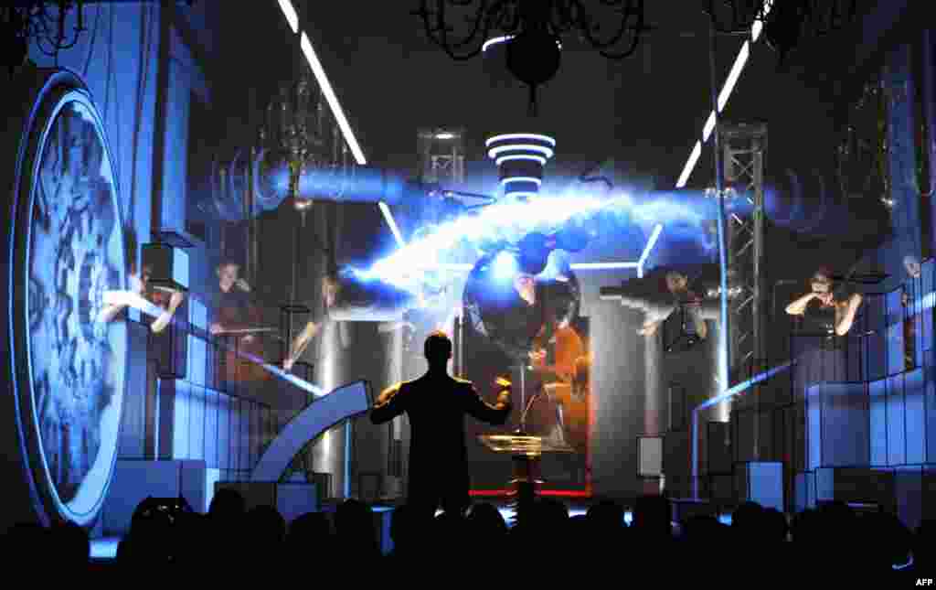 A man performs on stage during the official opening ceremony for activated energy links in Vilnius, by way of which Lithuania introduced new power lines to Sweden and Poland connecting the EU-member Baltic states to the Western energy market while reducing their dependence on imports from Russia. (AFP/Petras Malukas)