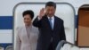 Chinese President Xi Jinping waves next to his wife, Peng Liyuan, as they board their plane for Hungary on May 8 following a two-day state visit to Serbia. 