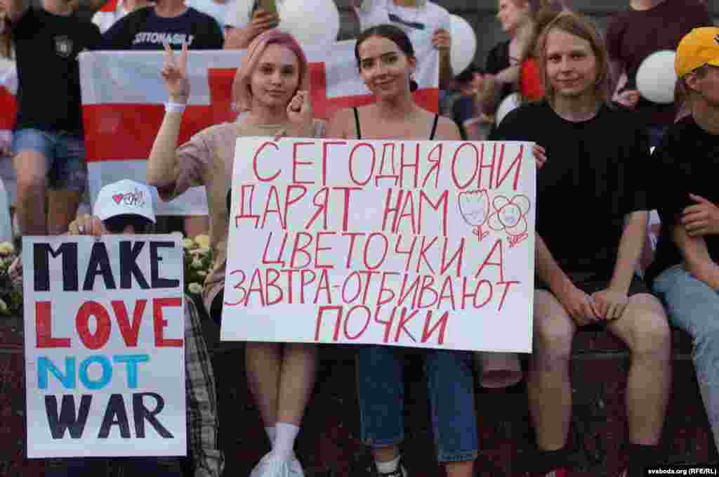 Belarusian women at a peaceful anti-government protest in Homel on August 16. The sign reads: &quot;Today they give us flowers. Tomorrow they beat our kidneys.&quot;