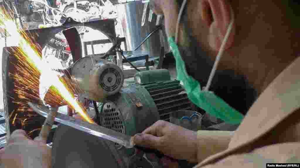 A man sharpens knives ahead of the ritual sacrificing of animals during Eid in Islamabad.