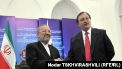 Georgian Foreign Minister Grigory Vashadze (right) welcomes his Iranian counterpart Manuchehr Mottaki to Tbilisi on November 3.