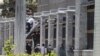 Iranian security and rescue officials outside parliament's administrative building, during the siege.