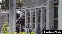 Iranian security and rescue officials outside parliament's administrative building, during the siege.