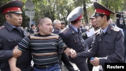 Police detain a protester during an opposition rally in Bishkek.