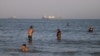 Vessels traverse the Strait of Hormuz near the beach of Bandar Abbas, Iran, on June 17. 
