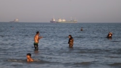 Vessels traverse the Strait of Hormuz near the beach of Bandar Abbas, Iran, on June 17. 