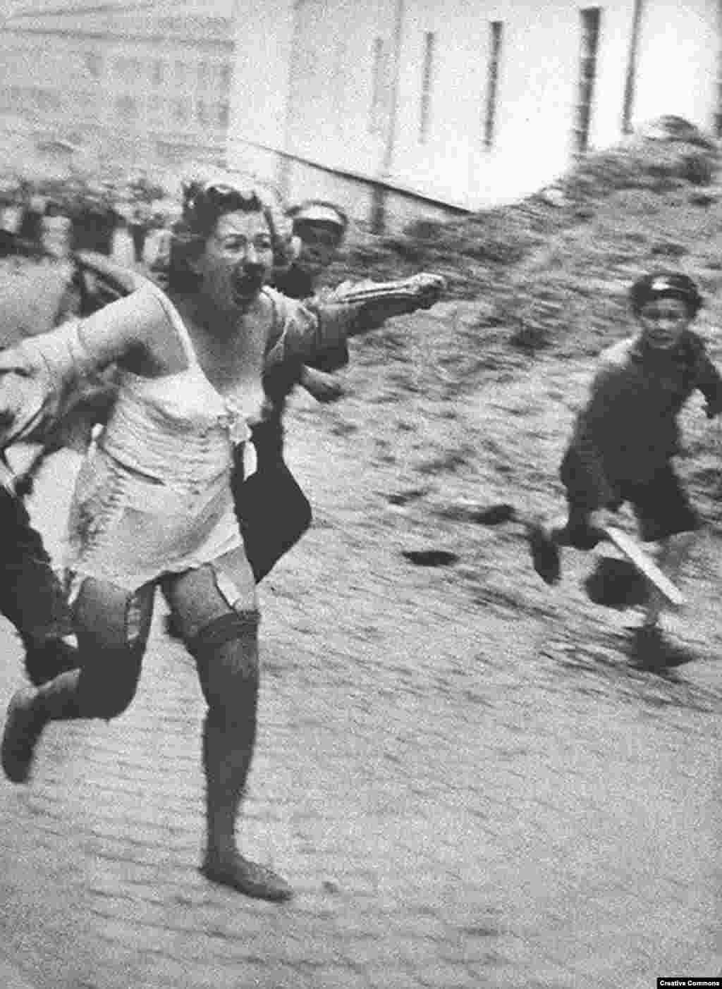 With the active encouragement of the Nazis, horror is unleashed on the Jewish population of the Soviet Ukraine and territories that had been occupied by Soviet forces. This woman is fleeing from a mob in Lviv, a Polish city overtaken by Soviet and then Nazi forces that is today part of western Ukraine -- in June or July 1941. Thousands of Jews were tormented and murdered by mobs of locals during a series of pogroms in Central and Eastern Europe. 