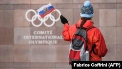 Շվեյցարիա - Համակիրը Ռուսաստանի դրոշն է թափահարում Միջազգային օլիմպիական կոմիտեի կենտրոնակայանի դիմաց, Լոզան, 5-ը դեկտեմբերի, 2017թ․