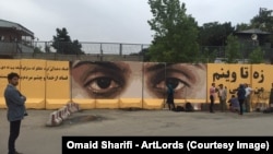 Afghan artist Omaid Sharifi's painting against corruption on a blast wall in Kabul.