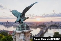 A "turul" -- a giant bird of prey in Hungarian mythology -- spreads its wings over the rising sun.