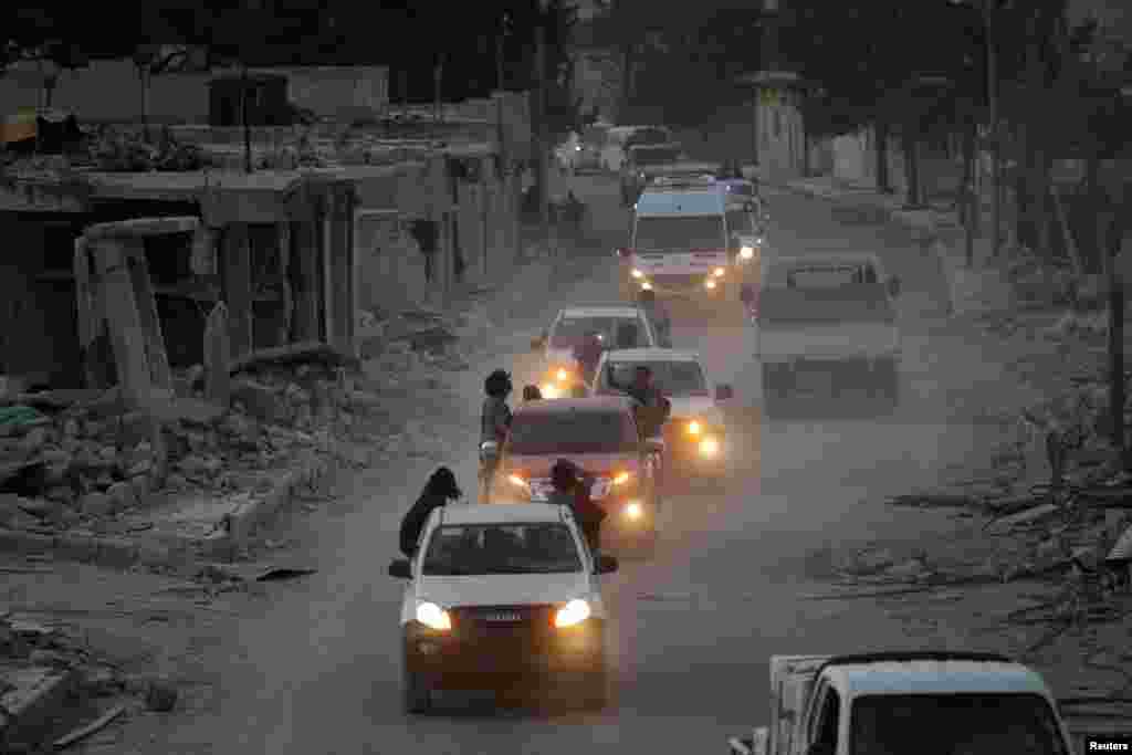 Rebel fighters in Syria drive their vehicles through the &nbsp;town of Al-Rai town in the northern Aleppo countryside on October 10. (Reuters/Khalil Ashawi)