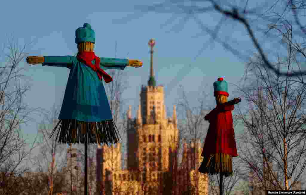 Effigies of Lady Maslenitsa are seen with a Stalin-era skyscraper in the background in central Moscow on February 25.