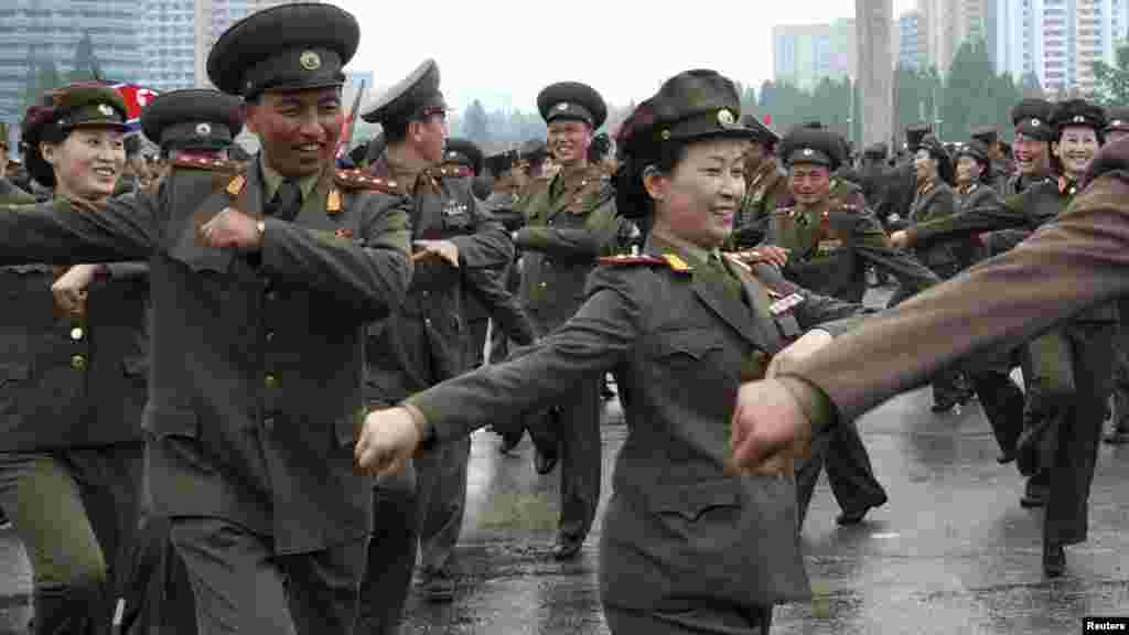 North Korean soldiers dance at an event in Pyongyang that was held to "offer their highest glory and congratulations" to Kim Jong Un upon his appointment as "marshal" of the country's army on July 18. (REUTERS)