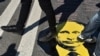 Protesters step on a sticker with an image of Russian President Vladimir Putin during a rally against the government's proposed reform hiking the pension age in Moscow in July.