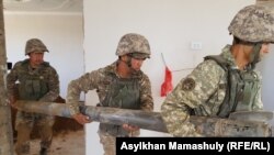 Оқ-дәрі қоймасындағы жарылыс кезінде үйге түскен снарядты қазып алып, әкетіп бара жатқан саперлар. Арыс қаласы, Түркістан облысы. 29 маусым 2019 жыл.