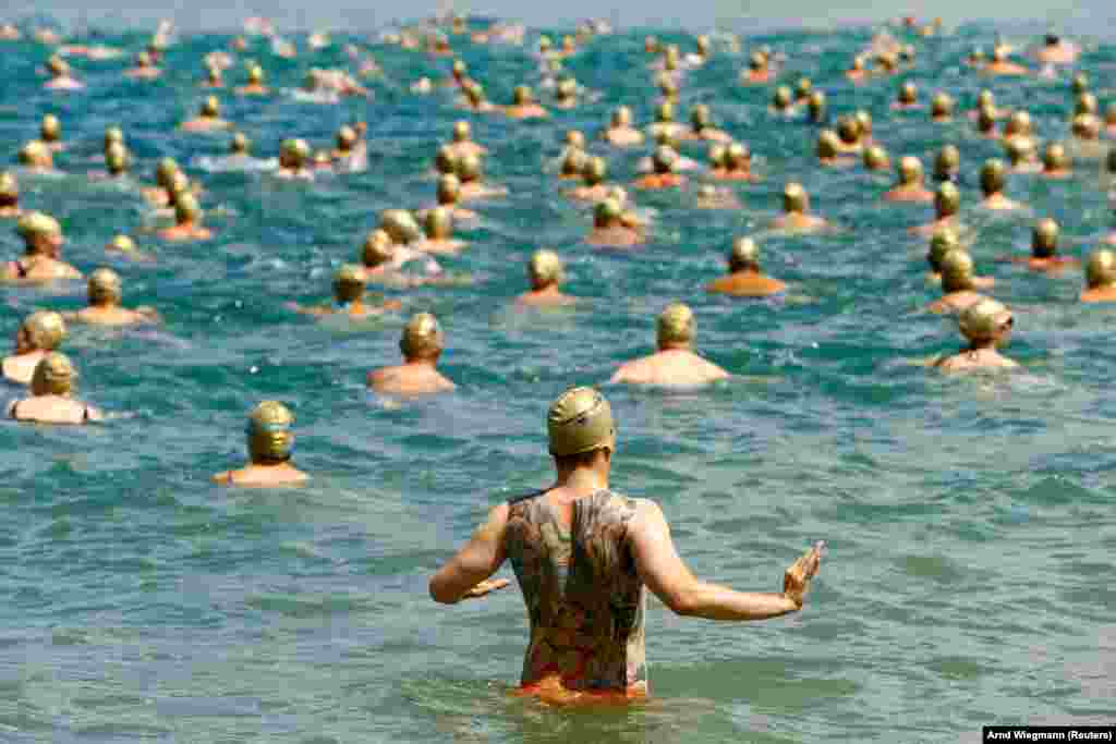 People participate in an annual Lake Zurich swimming event in Switzerland on July 11. (Reuters/Amd Wiegmann)