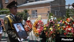  Armenia - A soldier holds the picture of Vahe Avetian during the military doctor's funeral in Yerevan, 2Jul2012. 