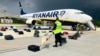 A Belarusian dog handler checks luggage from a Ryanair passenger jet, which made a forced landing at Minsk International Airport on May 23. Raman Pratasevich, a Belarusian journalist on board the flight, was subsequently arrested by the authorities. 