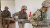 Military workers clear debris in the aftermath of the explosion in Arys, a small town in the Turkestan region, in June 2019.