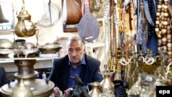 An Iranian man sits in his shop at the old bazaar in the city of Qazvin, Iran, October 2016