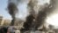 Smoke rises from an Aleppo bus station hit by what activists said was an air stike by forces loyal to Syria's President Bashar al-Assad on January 21.
