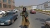 A Taliban fighter stands guard along a street near in Kabul, September 23, 2021.