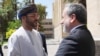 Iranian Foreign Minister Abbas Araqchi (right) greets Omani Foreign Minister Sayyid Badr al-Busaidi in Tehran on August 25, as Tehran and Muscat seek a way to ensure safe passage through the Strait of Hormuz.