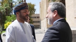 Iranian Foreign Minister Abbas Araqchi (right) greets Omani Foreign Minister Sayyid Badr al-Busaidi in Tehran on August 25, as Tehran and Muscat seek a way to ensure safe passage through the Strait of Hormuz.