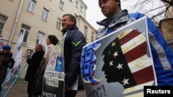 Russian protesters outside the office of the election-monitoring NGO Golos in Moscow accuse the group of foreign ties. Rodger Potocki says the NED doesn't "ascribe to this idea that there are phrases or approaches that are foreign or domestic, that are internal or external." 