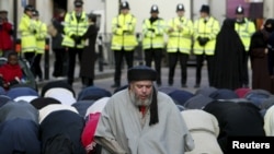 Radical Muslim cleric Abu Hamza al-Masri is seen leading prayers outside the North London Central Mosque in Finsbury Park, north London, in 2003.