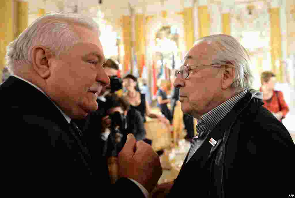 Walesa talks with film director Andrzej Wajda during a ceremony at Warsaw's Royal Castle on June 4, 2013. Wajda is the director of "Walesa: The Man Of Hope," a controversial new biopic about Walesa's life and political career. 