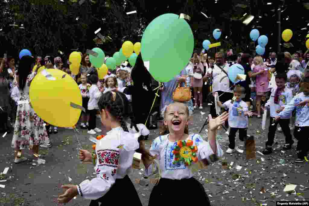 Ukrainian children -- many wearing the traditional &quot;vyshyvanka&quot; embroidered shirts -- celebrate their first day of school in Zaporizhzhya on September 1. &nbsp;