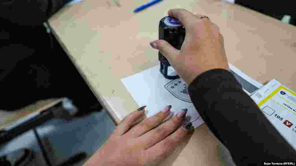 Službenica Centralne izborne komisije ovjerava glasački listić tokom drugog kruga izbora za gradonačelnika u glavnom gradu, Prištini, 9. novembra 2025.