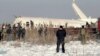 Kazakhstan -- Police guard as rescuers work on the side of a plane crashed near Almaty International Airport, outside Almaty, Kazakhstan, Friday, Dec. 27, 2019