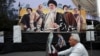 A billboard in Tehran depicts Iran's late Supreme Leader Ayatollah Ali Khamenei, late former Hezbollah leader Hassan Nasrallah, and late military commander Qassem Soleimani, on October 6.