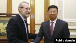 Iran's parliament speaker Ali Larijani meeting China's Song Tao in Tehran on July 30, 2019.