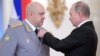 Russian President Vladimir Putin (right) decorates Colonel General Sergei Surovikin (left) during a ceremony at the Kremlin to present state awards to Russian soldiers who fought in Syria in December 2017.