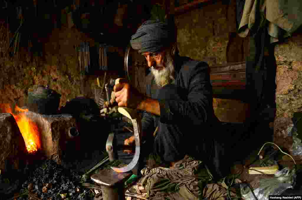 An Afghan blacksmith forges a tool at his workshop in Herat city. (AFP/Hoshang Hashimi)