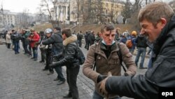 Protestatari construind o baricadă după ciocnirile cu poliția la Kiev, 20 februarie 2014